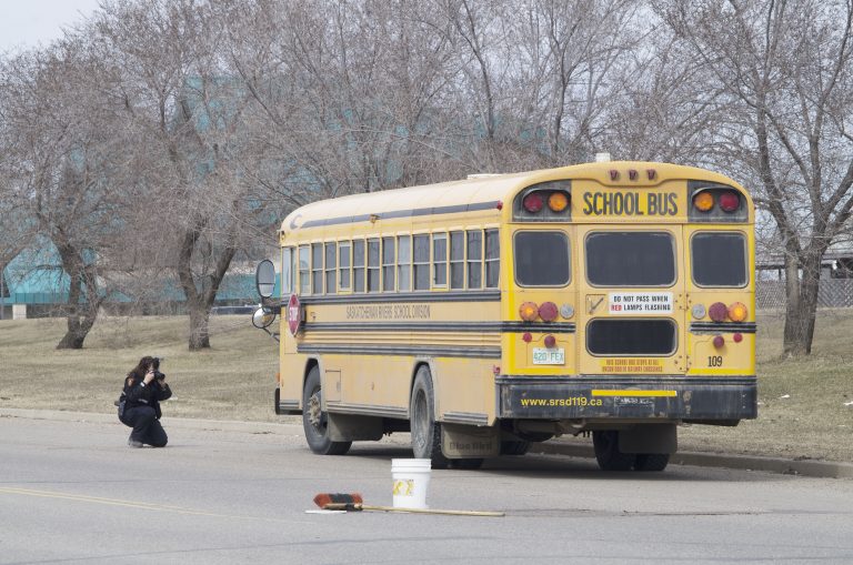 Pedestrian struck by bus dies