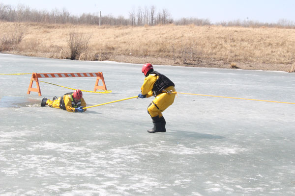 Fire Department conducting ice rescue training near Victoria Hospital